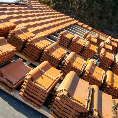 stacks-of-yellow-ceramic-roofing-tiles-for-covering-residential-building-roof-under-construction.jpg