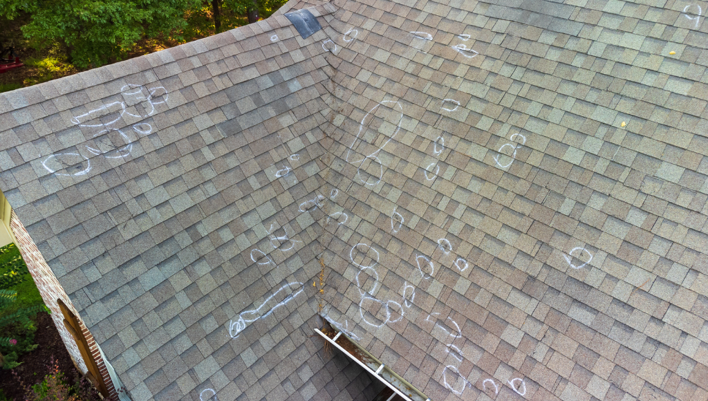 Damaged roof with marked areas after roof inspection